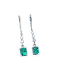 14K white gold dangle earrings with square Colombian emeralds and diamond accents.