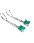 Pair of emerald dangle earrings, right profile top view