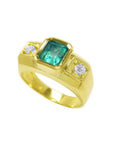 Gold ring with a genuine emerald and two diamonds on a top and sides view profile.