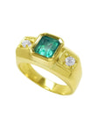 Men's 18K yellow gold ring with a rectangular emerald and two round accent diamonds.