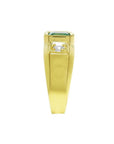 Men's 18K yellow gold ring with a medium bluish green emerald and two accent diamonds.