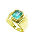 Men's 18K yellow gold solitaire ring with a rectangular Colombian emerald in a full bezel setting.