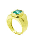 Men's 18K yellow gold ring with a rectangular emerald-cut Colombian emerald in a full bezel setting.