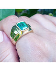 Men's 18K yellow gold ring with a rectangular Colombian emerald in a full bezel setting.