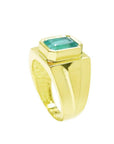 Men's 18K yellow gold solitaire ring with a rectangular Colombian emerald in a full bezel setting.