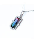 The left side profile of a watermelon tourmaline pendant in white gold and diamonds.