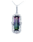 A brazilian watermelon tourmaline gemstone pendant with diamond accents on a topside view position.
