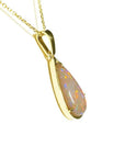 Pear-shaped Australian opal pendant with fiery red/orange hues in 14k yellow gold setting on a chain.
