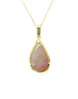 Pear-shaped Australian opal pendant with red/orange fire, set in 14k yellow gold on a delicate chain.