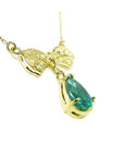 18K yellow gold bow-tie necklace with pave yellow diamonds and a dangling pear-shaped emerald.
