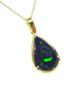 Teardrop-shaped Ethiopian black opal pendant with gold setting on a right-side profile view.