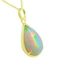 Radiant 9.29 ct. Ethiopian opal teardrop pendant in 14K solid yellow gold, displaying a full spectrum of colors.