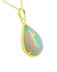 Radiant 9.29 ct. Ethiopian opal teardrop pendant in 14K solid yellow gold, displaying a full spectrum of colors.