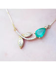 14K yellow gold twig necklace with a pear-cut natural emerald and diamond accents.
