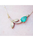 14K yellow gold twig necklace with a pear-cut natural emerald and diamond accents.