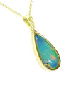Ethiopian opal pear pendant with blue-violet play-of-color in 14K yellow gold.