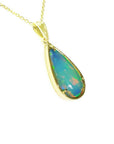Ethiopian opal pear pendant with blue-violet play-of-color in 14K yellow gold.