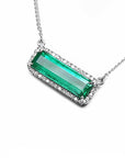 18K white gold necklace with a rectangular Colombian emerald and diamond halo, East-West design.