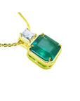 18k gold necklace with an Asscher cut emerald gemstone pendant and princess cut diamond on a white background