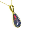 Gold pendant with a teardrop-shaped opal stone on a right-side profile view.