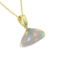Opal pendant necklace with gold chain on a right-side profile view.