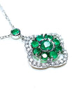 A 14k white gold necklace with genuine round cut colombian emeralds cluster pendant.