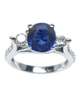 Women's natural blue sapphire ring side diamonds three stone white gold, half tall top view