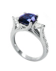14K white gold ring with a deep blue oval sapphire and accent diamonds.