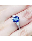 Women's natural blue sapphire ring side diamonds three stone white gold, on a woman's hand