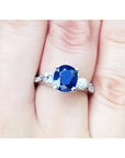 Women's natural blue sapphire ring three stone white gold, accent natural diamonds prong set in a Lucida style.