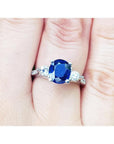 Women's natural blue sapphire ring three stone white gold, accent natural diamonds prong set in a Lucida style.
