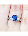 Women's natural blue sapphire ring three stone white gold, accent natural diamonds prong set in a Lucida style.