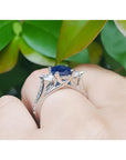 1.84 ct oval blue sapphire ring with side diamonds in 14K white gold.