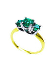 Round cut three-stone emerald ring, 0.62 cttw, with prong-set stones in white and yellow gold.