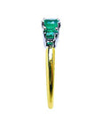 A side profile perspective of this natural emerald ring.