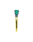 Lucida style round cut three-stone emerald ring with white and yellow gold band.