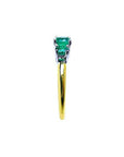 Lucida style round cut three-stone emerald ring with white and yellow gold band.