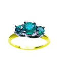 A three stone emerald ring with round cut emeralds, May's birthstone, featuring a combination of white and yellow gold.