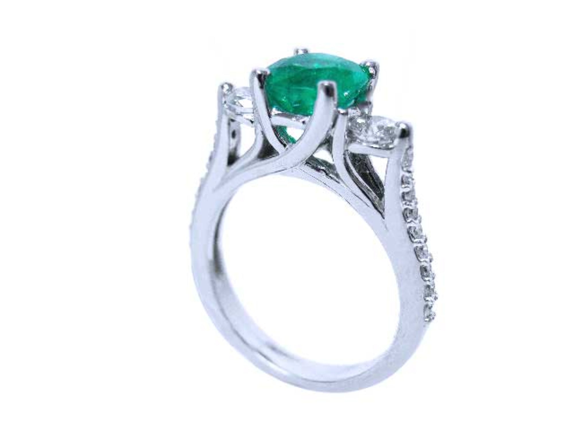 On top a round cut emerald and downside profile half side view of this emerald ring.