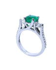 On top a round cut emerald and downside profile half side view of this emerald ring.