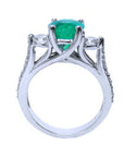The lateral profile of a round cut emerald ring, displaying top, gallery and band of the ring visibles.