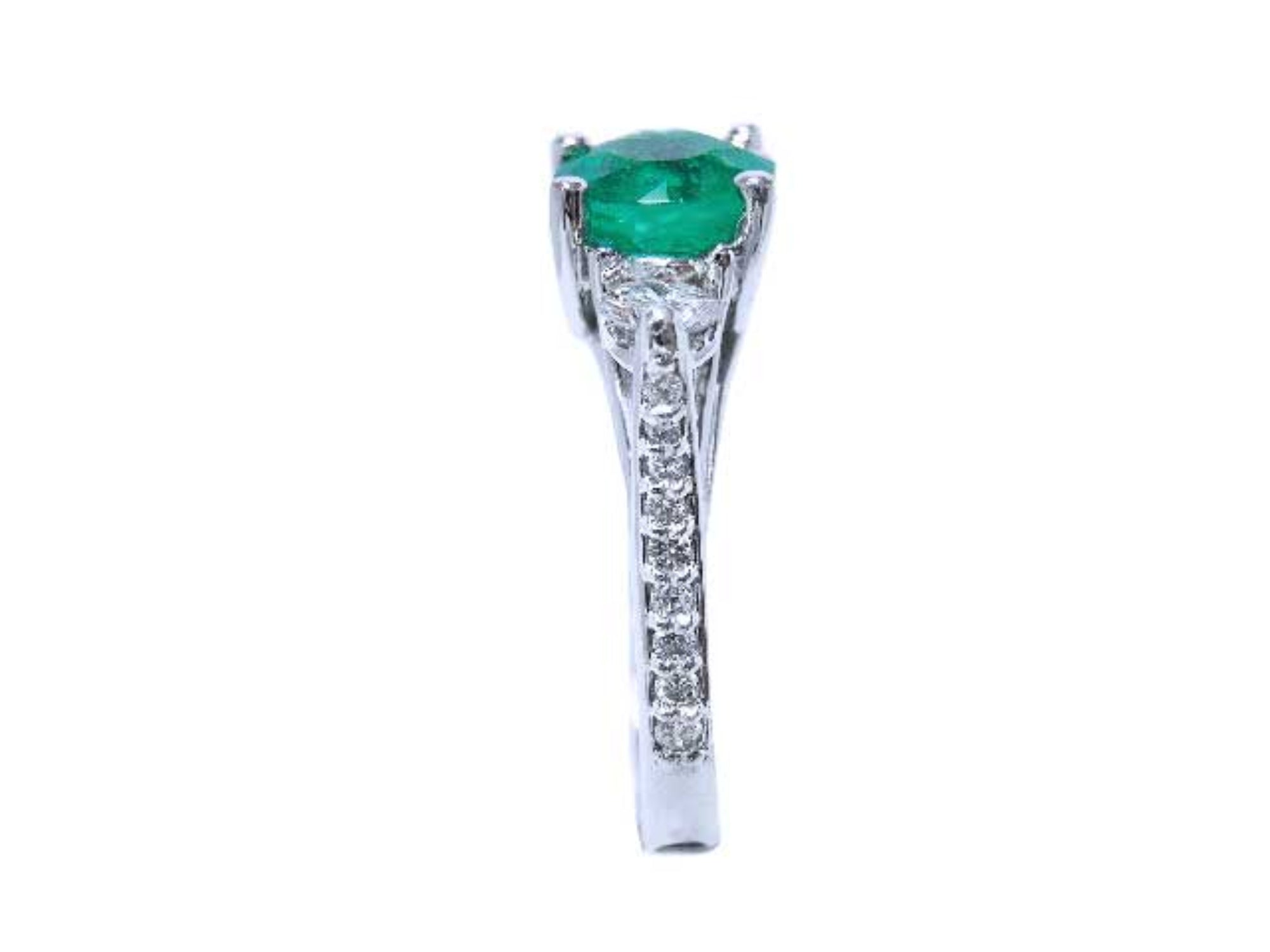A round cut emerald ring displaying on top the main gemstone and side band ring with diamonds profile.