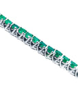 Emerald tennis bracelet round cut Muzo Colombian emeralds 14k white gold sparkling medium deep green color prong set.