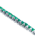 Emerald tennis bracelet round cut Muzo Colombian emeralds 14k white gold sparkling medium deep green color prong set.