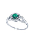 14K white gold ring with a round emerald center stone and diamond halo.