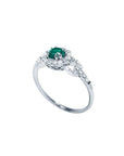 14K white gold ring with a round emerald center stone surrounded by a halo of natural diamonds.