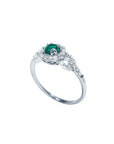 14K white gold ring with a round emerald center stone surrounded by a halo of natural diamonds.
