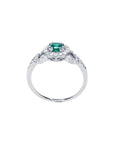 A detailed view of the round cut emerald with a halo diamond ring, highlighting the top, side gallery, and band.