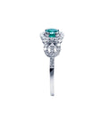 Round emerald halo ring with natural diamonds set in 14K white gold.