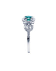 Round emerald halo ring with natural diamonds set in 14K white gold.